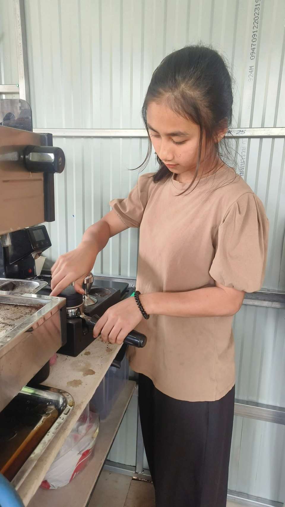 Youth practice making coffee