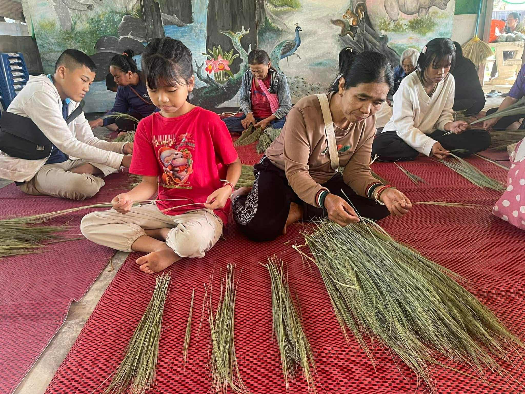 Organizing broom grass by size to ensure consistency and quality in our handcrafted brooms.