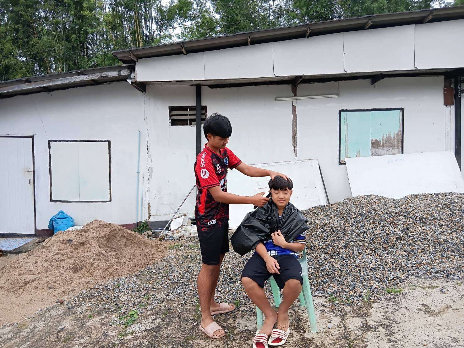 The children use chairs and equipment borrowed from local villagers.