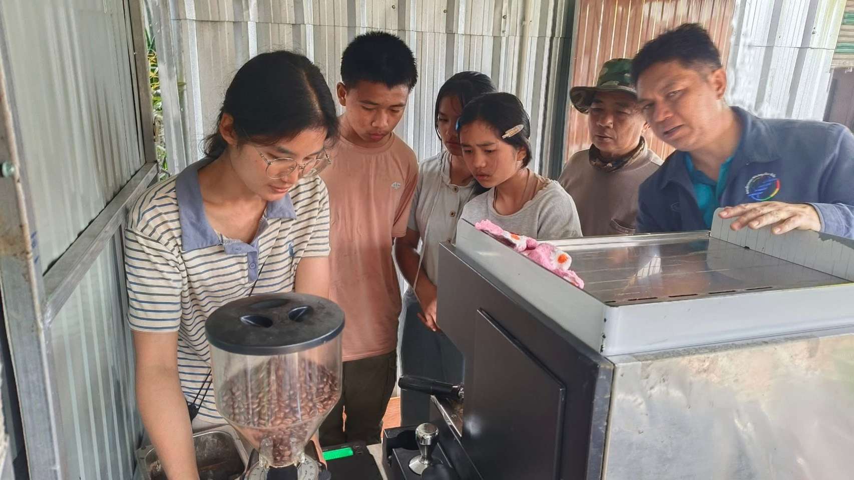 Youth learn how to make coffee from baristas (Compassion alumni)