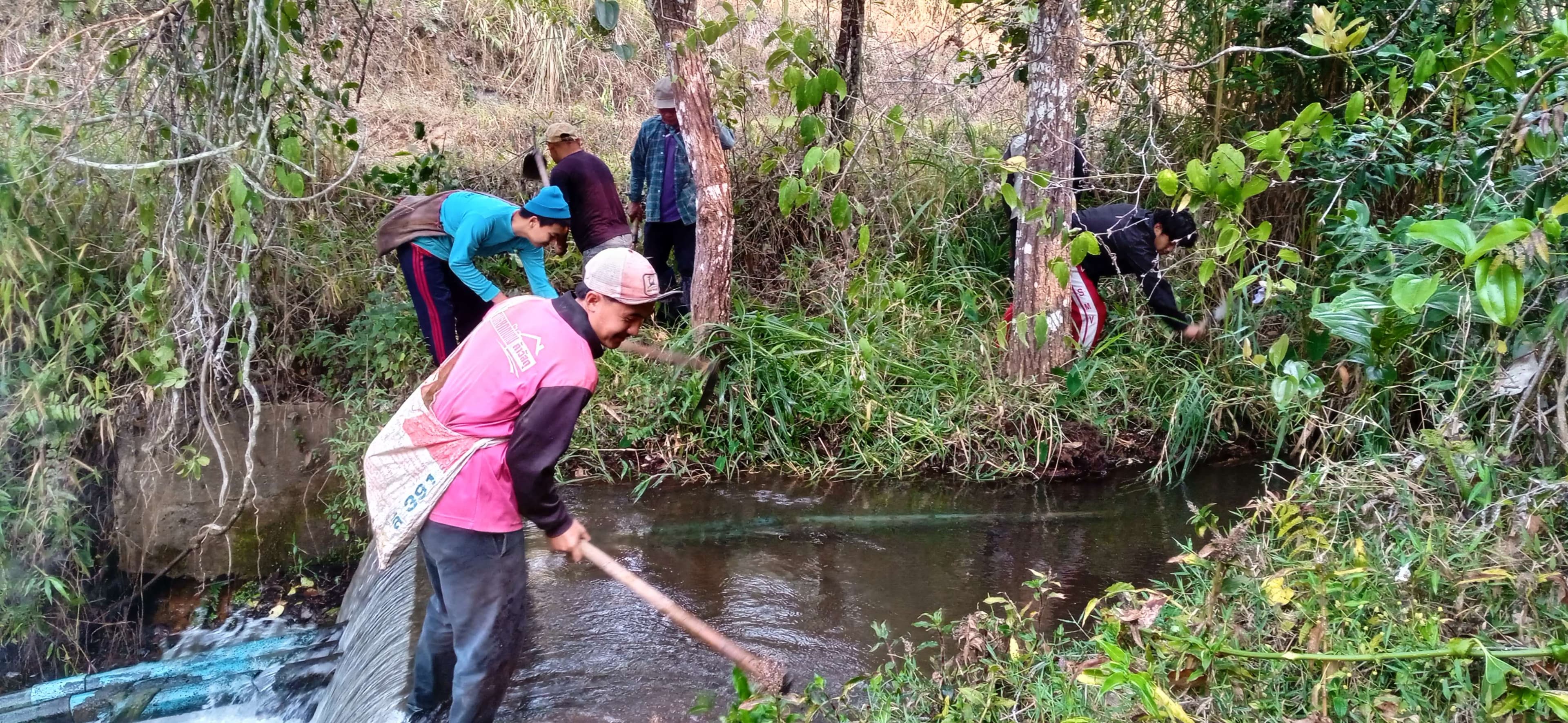 Parents and children help clean the river.