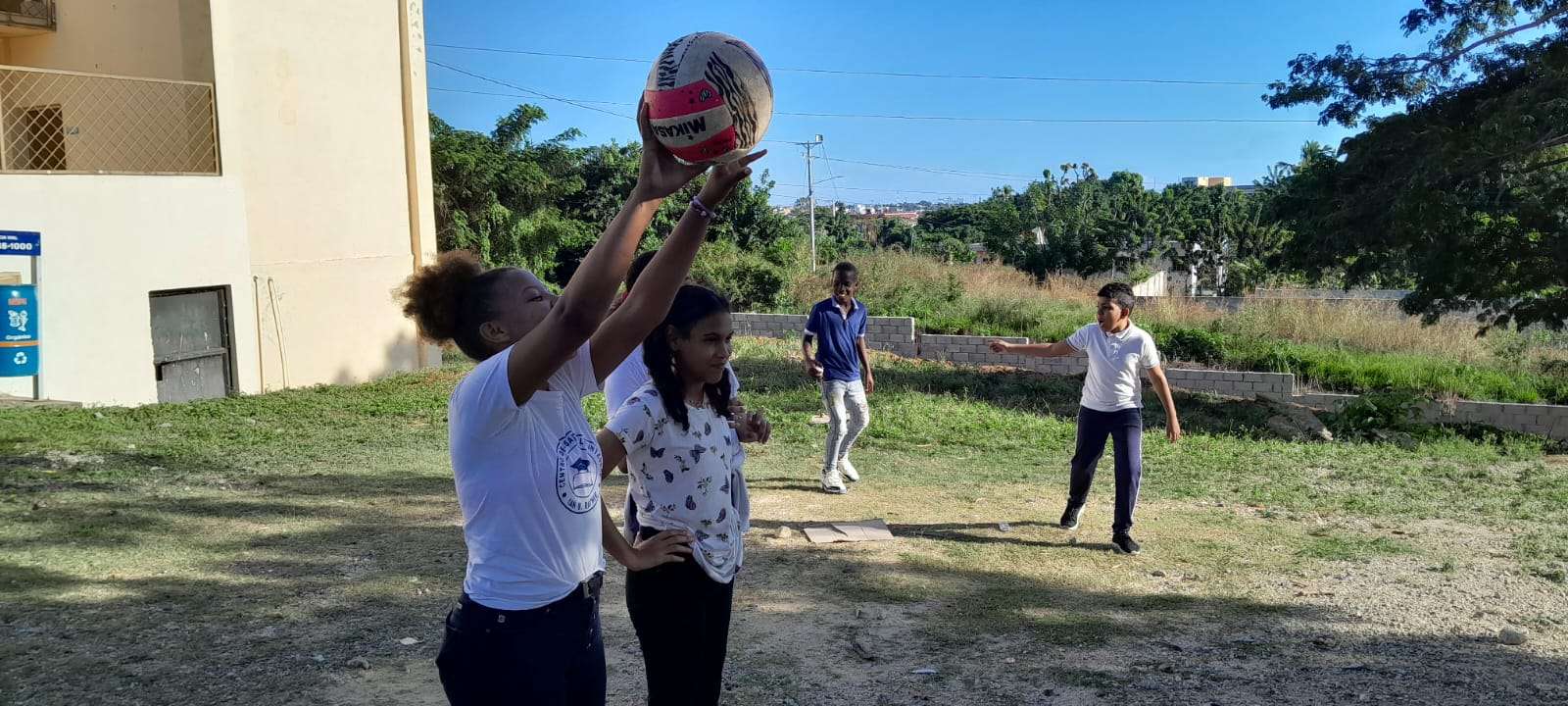 Teenagers from the center playing volleyball