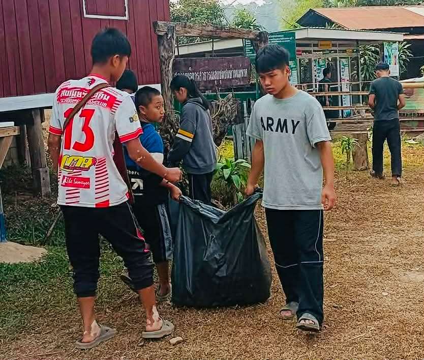 Children collect garbage outside houses