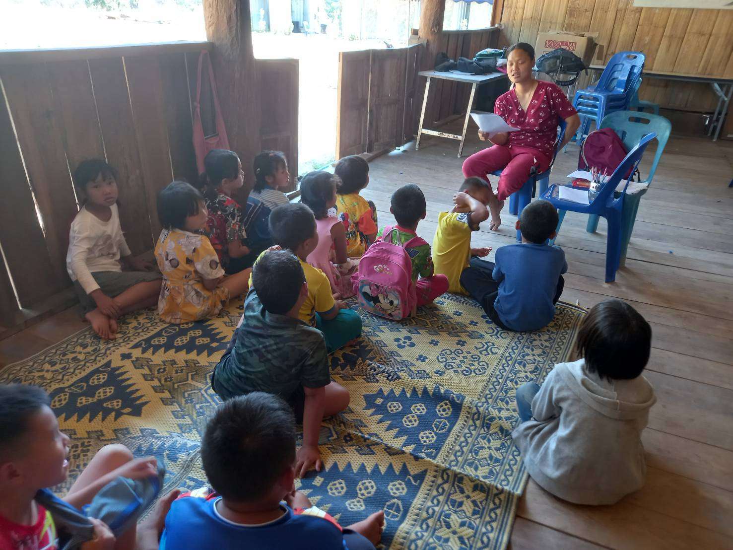 Children studying in areas that are not conducive to learning, highlighting the urgent need for a proper, comfortable environment to enhance their educational experience.