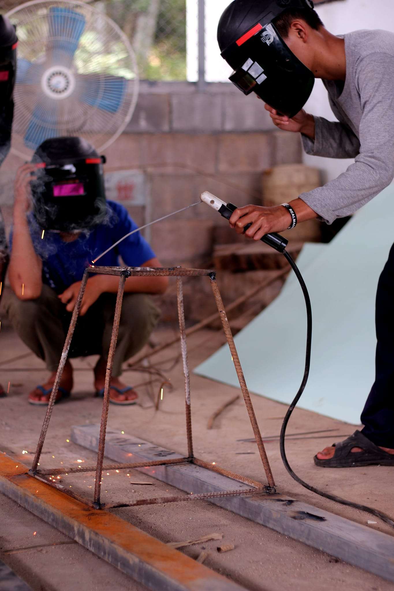 Children learn vocational skills from welding teachers.