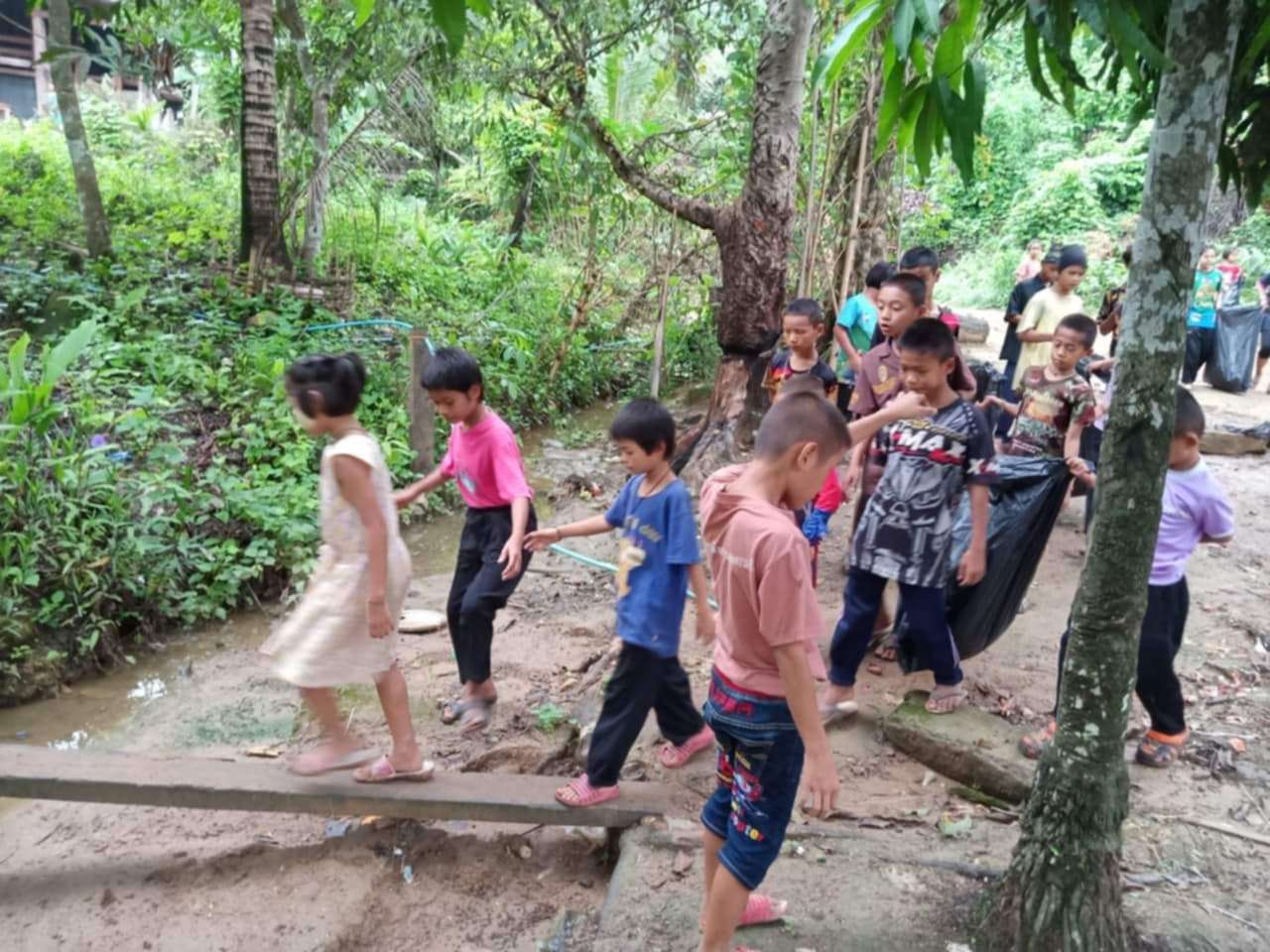 Young hands making a big impact: Children join together to clean up the canal and protect our village environment