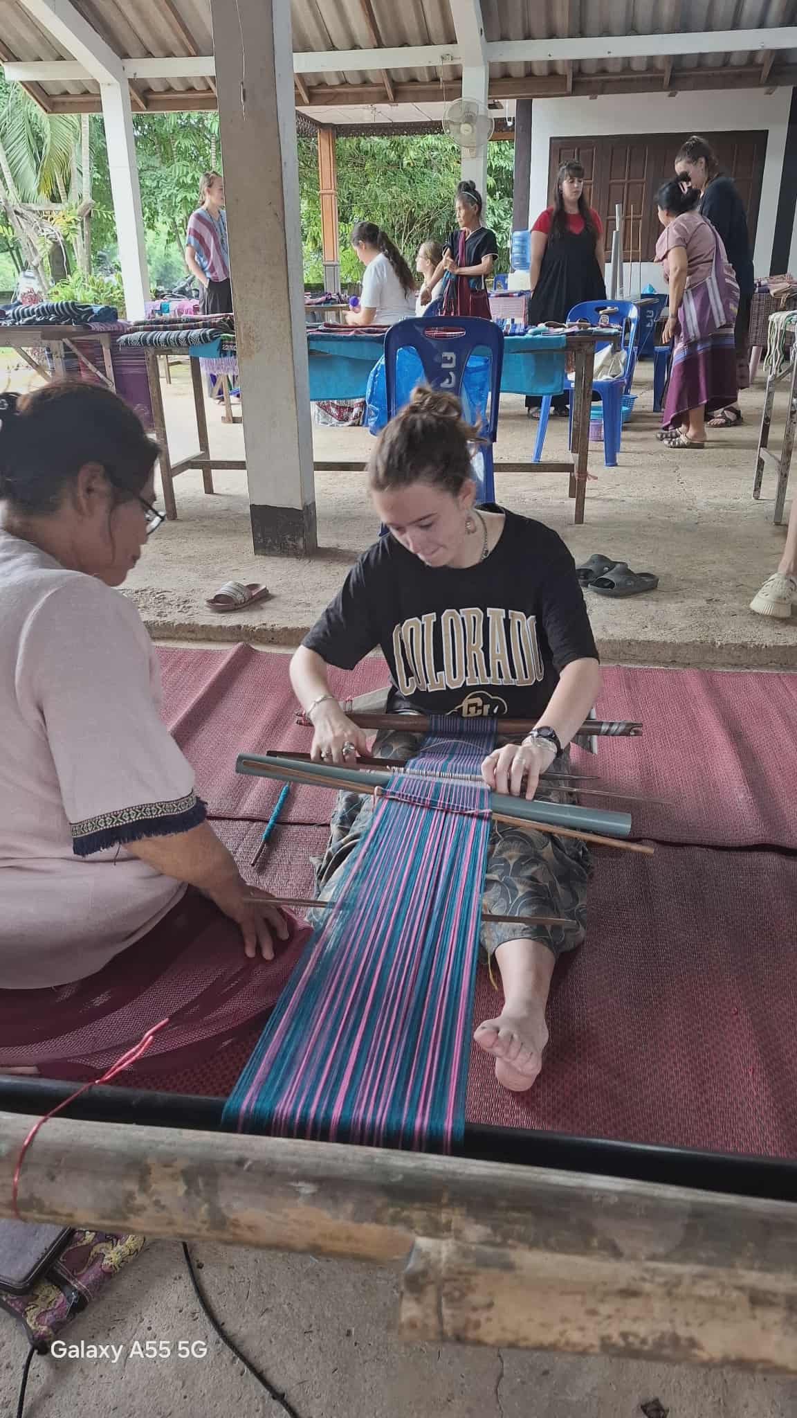 Visitors are learning to weave with the children's parents.