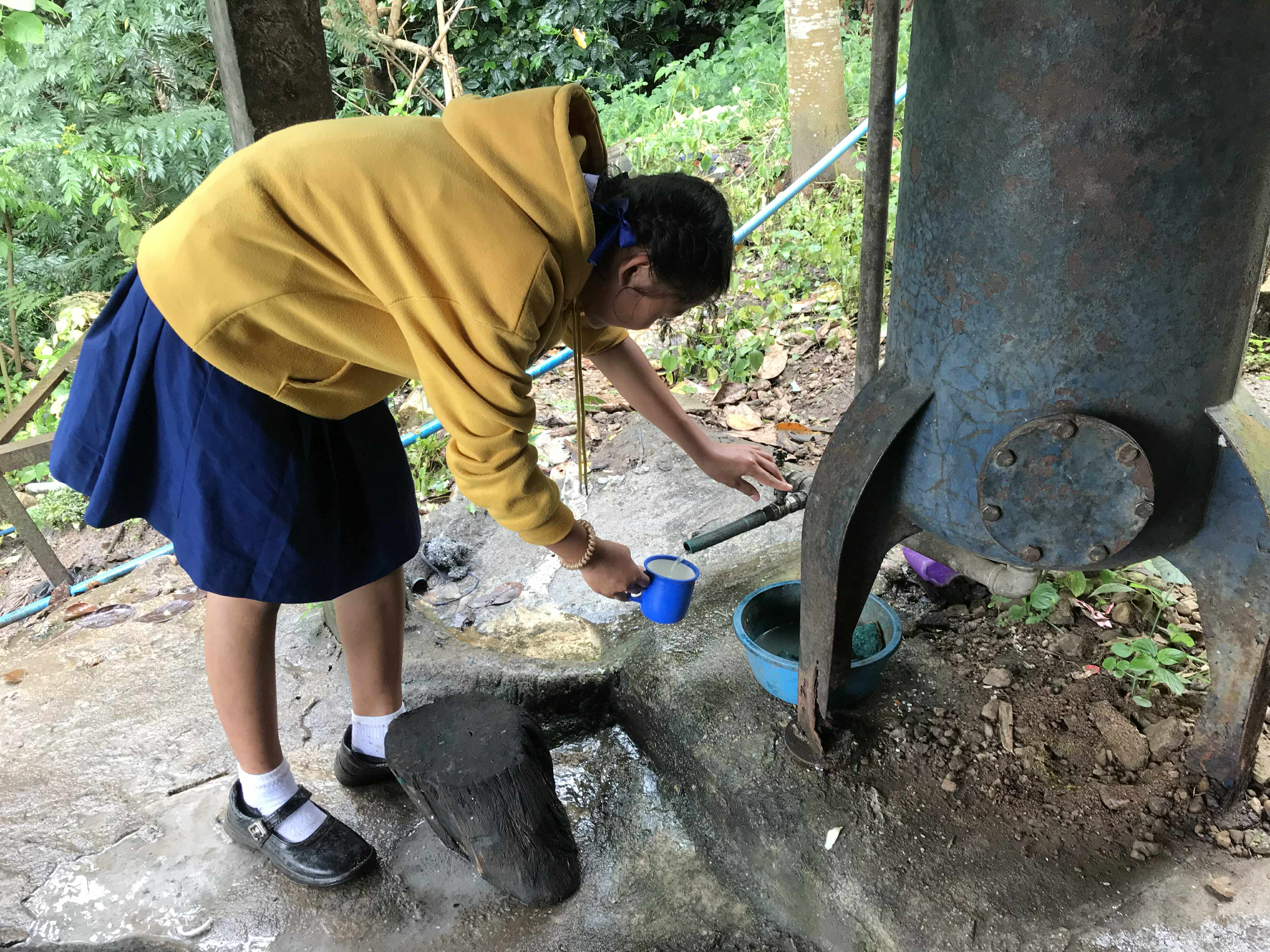 Children and youth drinking water from old, potentially less effective water filters, which may no longer provide optimal safety and cleanliness.