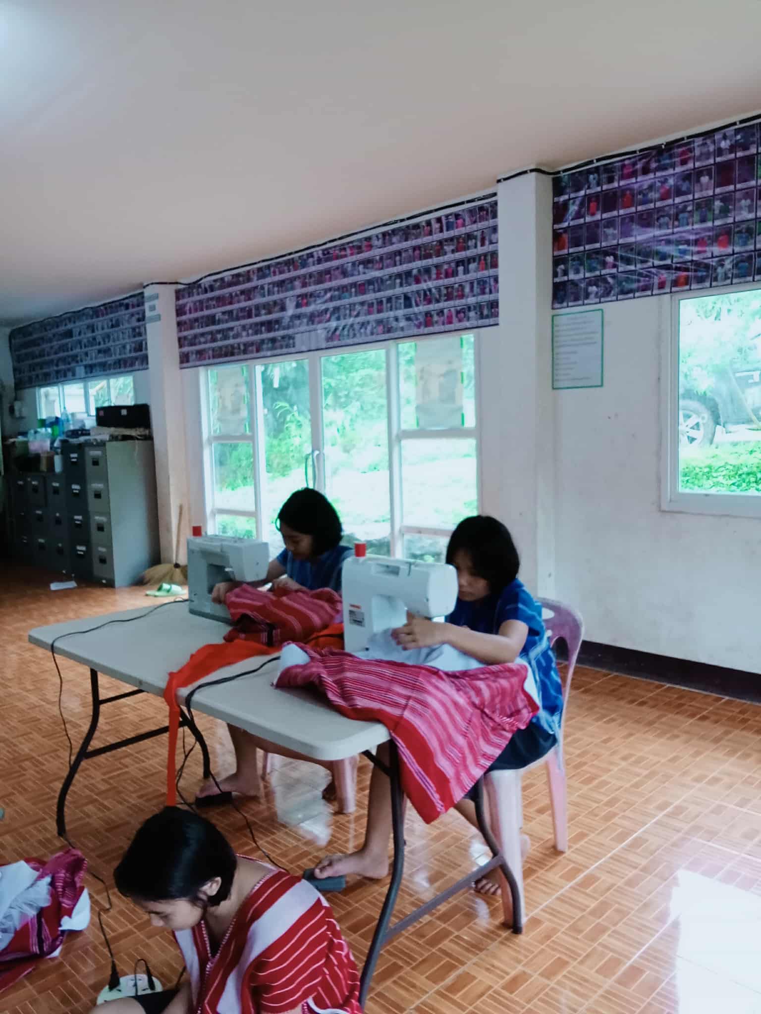 Children practicing their sewing techniques.