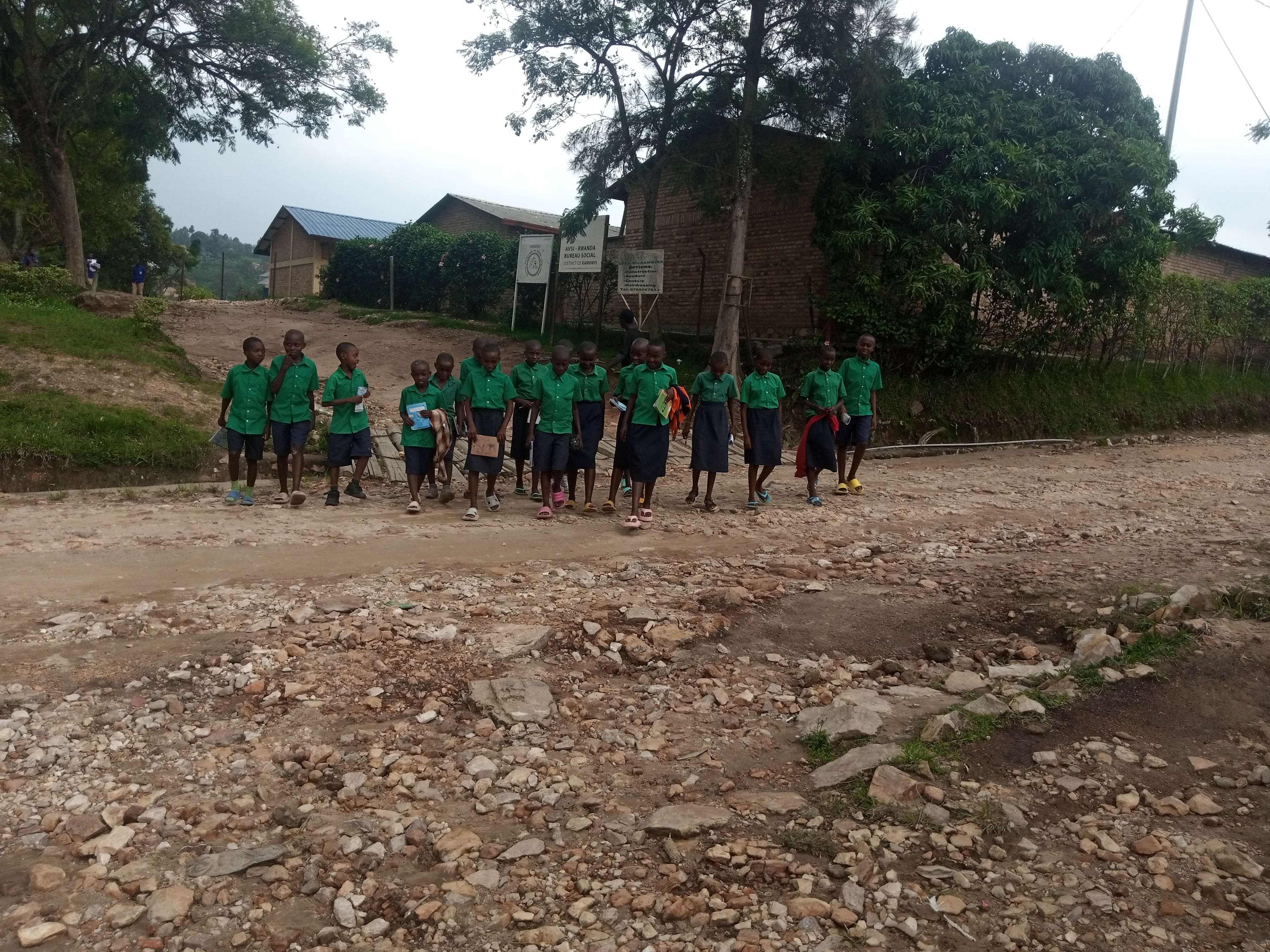 The children crossed the street in order to reach the school where there is desks.