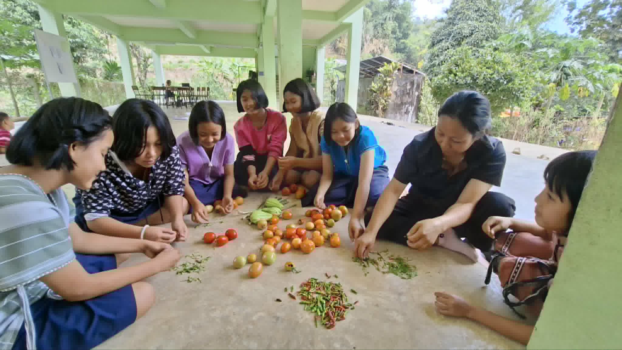 Children gather local produce to learn and grow together.