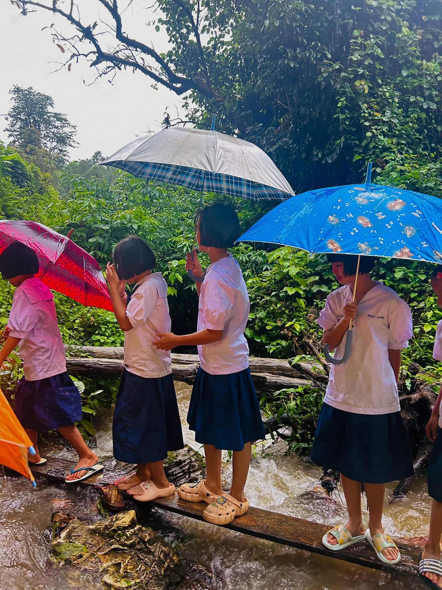 "A glimpse of the temporary bridge currently in use, highlighting the challenges faced by the community in crossing the stream."