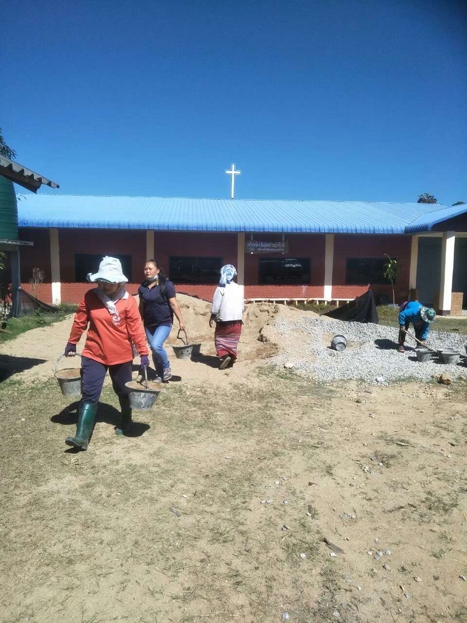 The parents and guardians helped carry the rocks and sand.