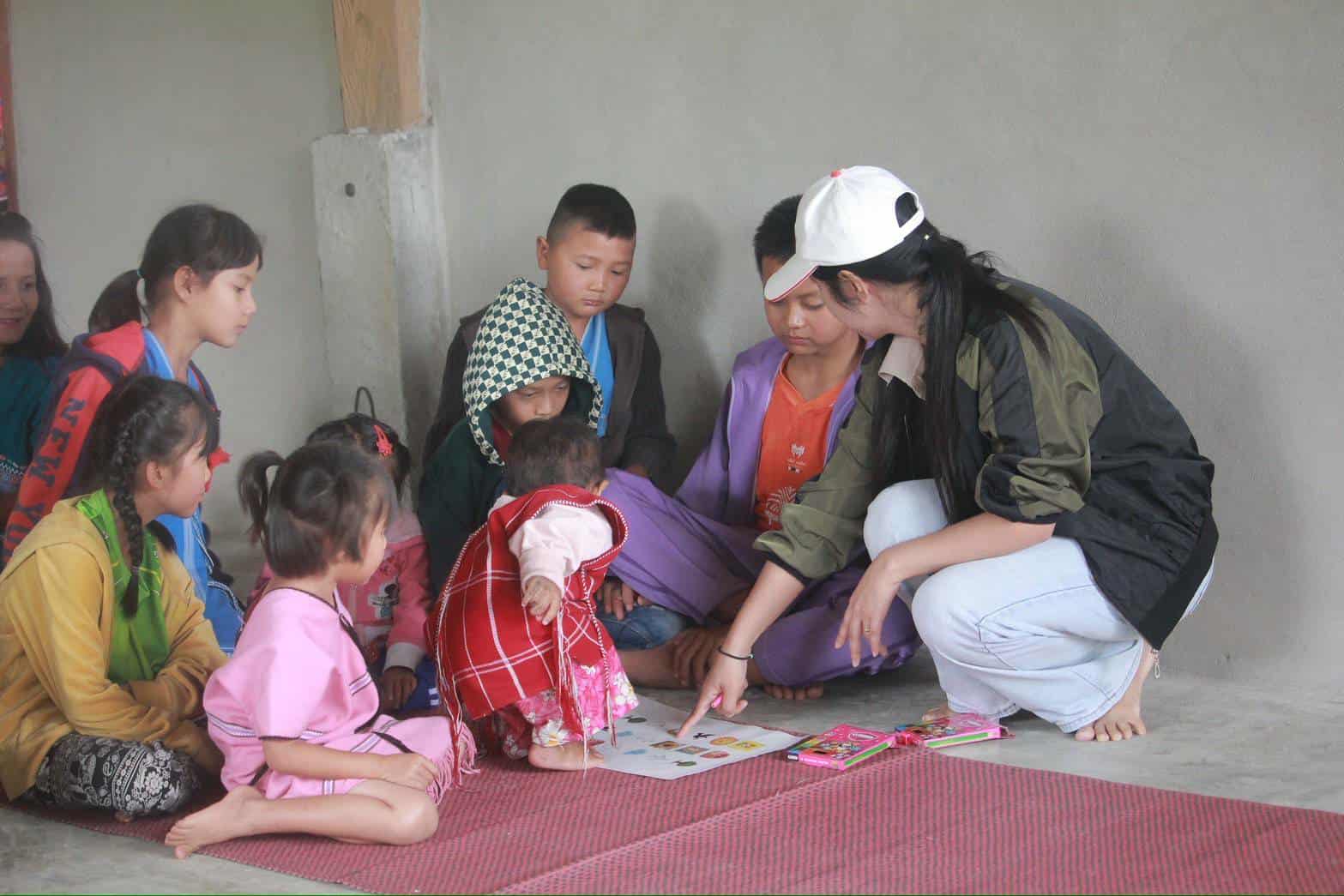 Learning in progress: A child engages with their teacher, demonstrating resilience and determination while studying on the floor.