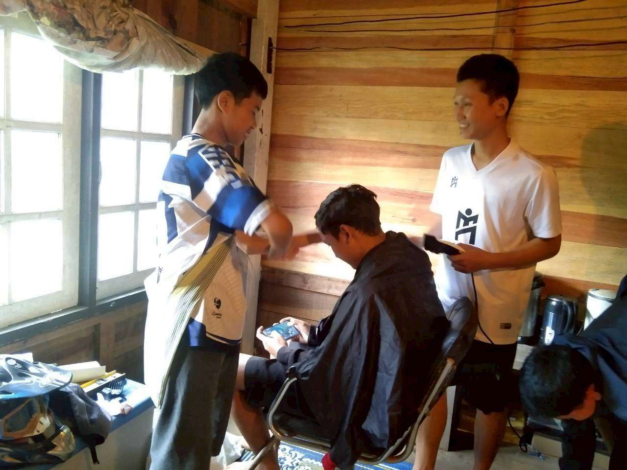 Older youth learn skills in using hair cutting tools.