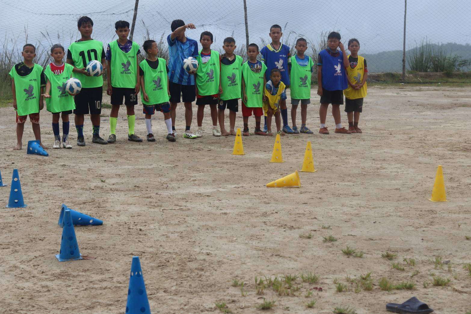 Children actively participating in developing their football skills.