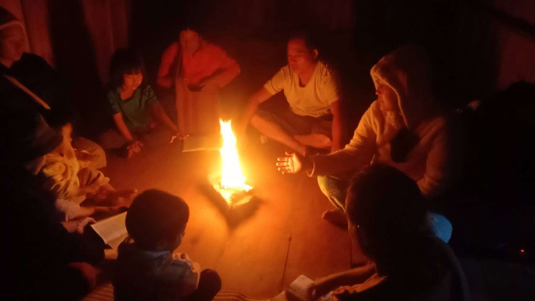 "Community members come together to study the scriptures by firelight, sharing insights and strengthening their faith."