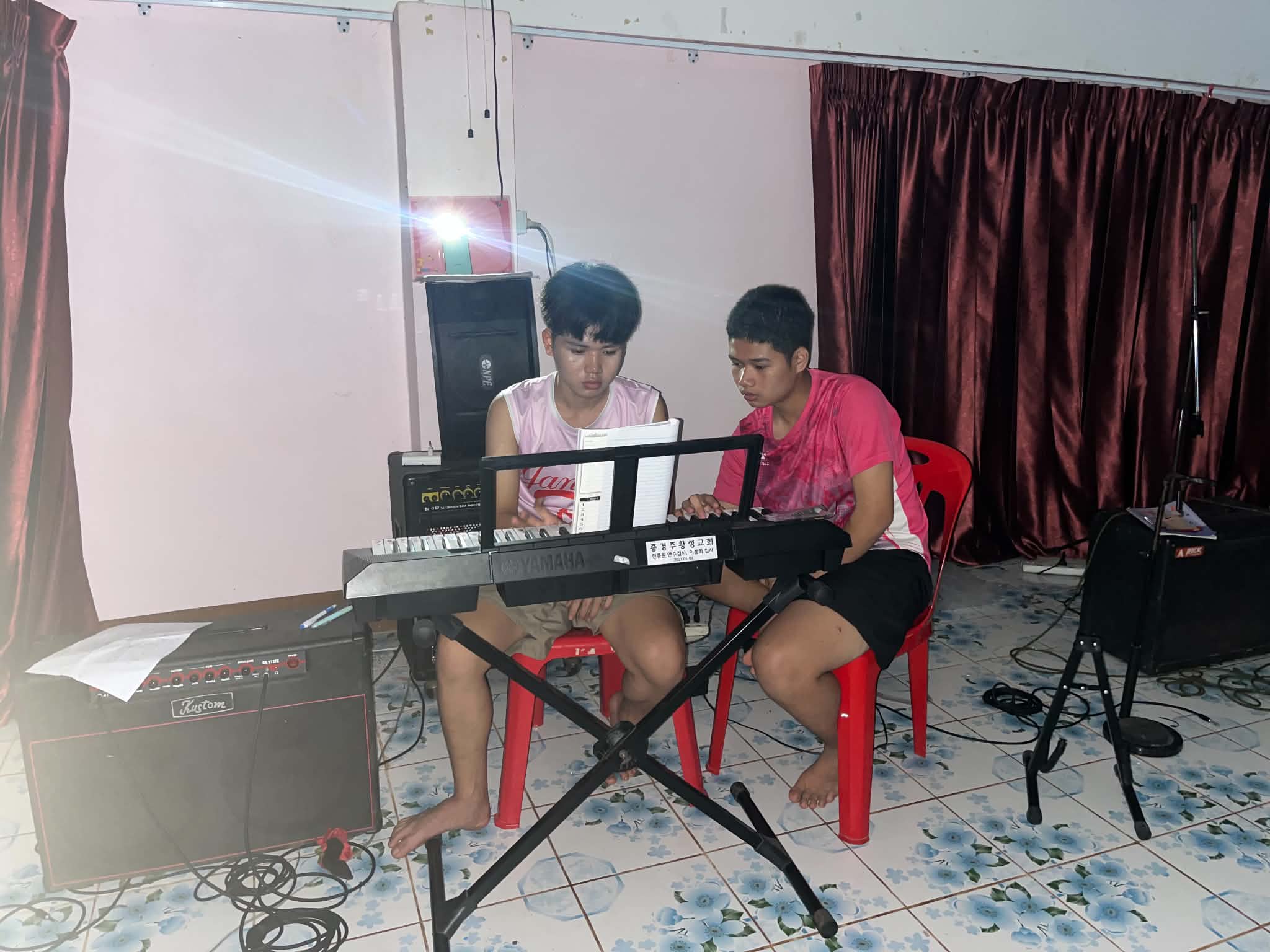 Young people practice piano to develop their musical skills.