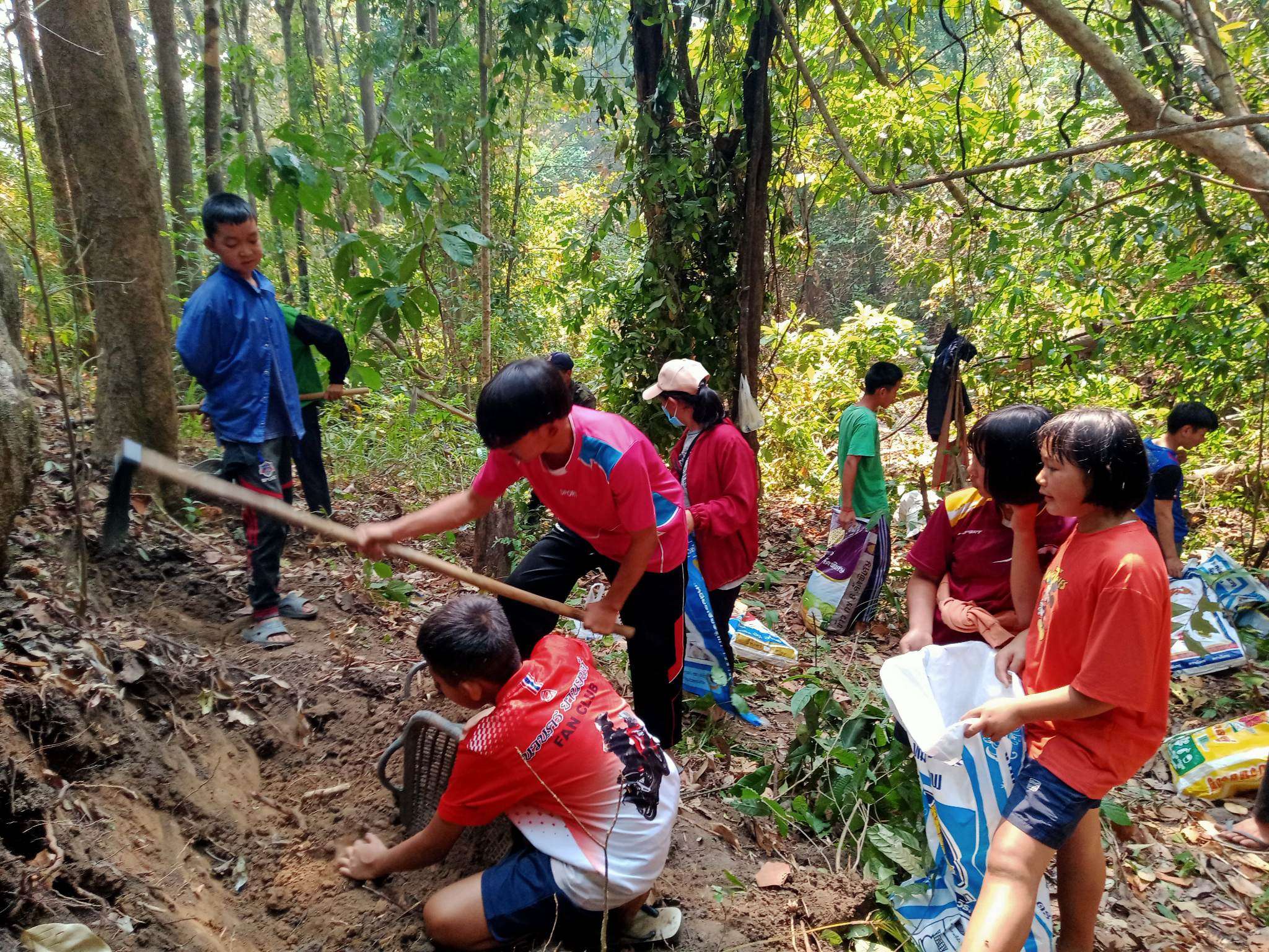 Children digging a fish pond