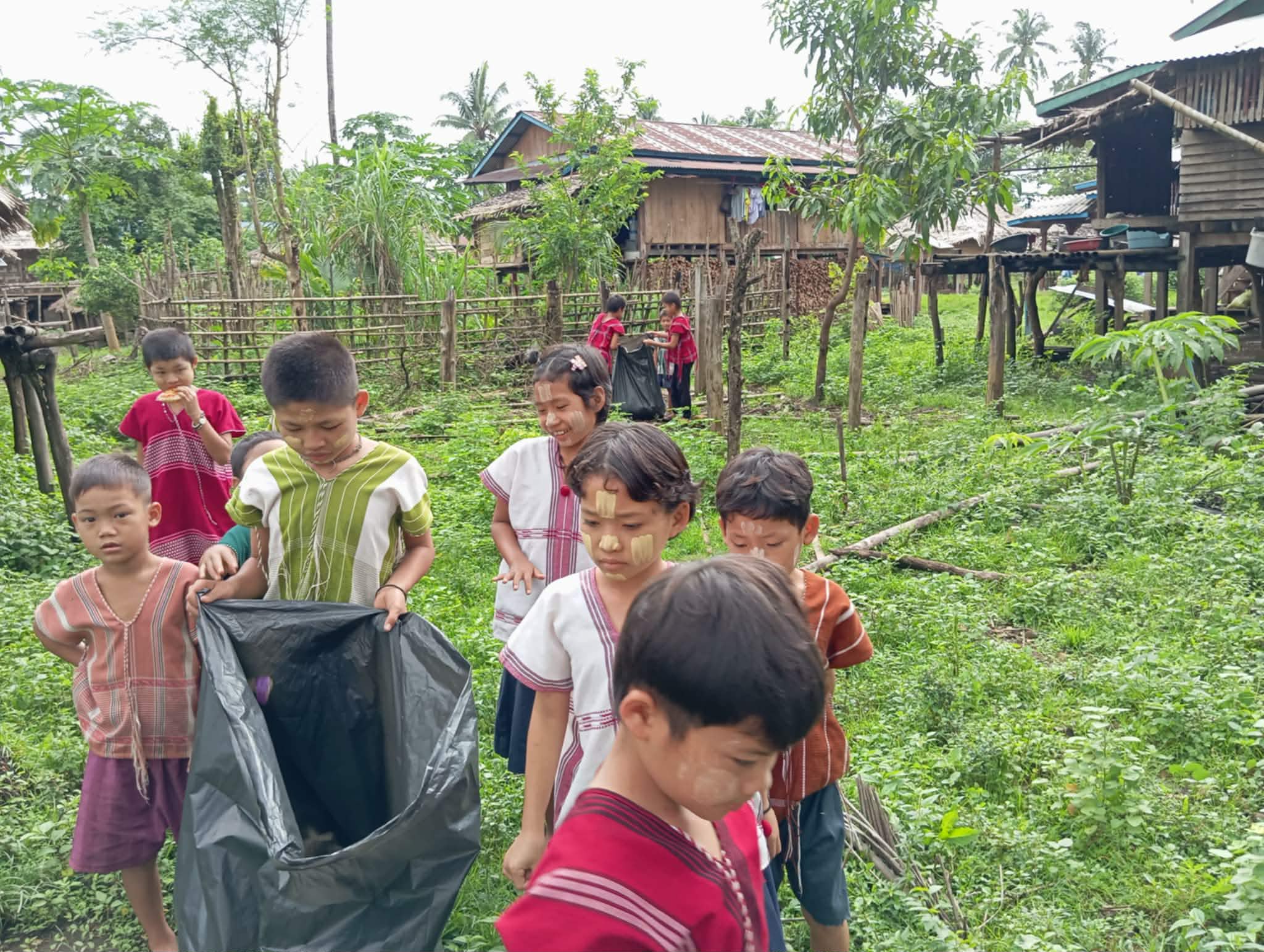 Children picking up trash in the community.