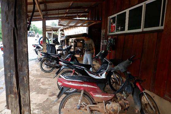 Customers' motorcycles waiting in line for repair.