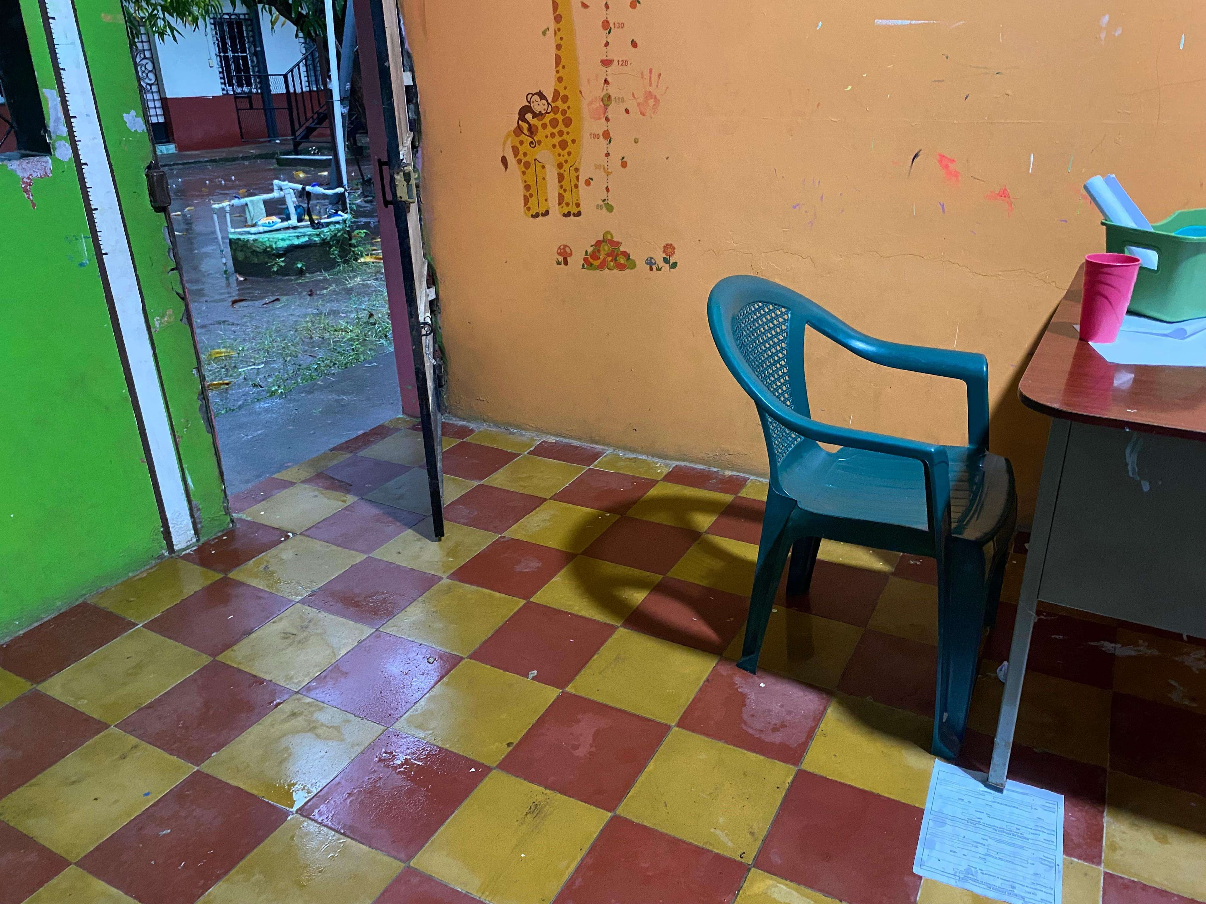 Interior of classroom with rain leaks.