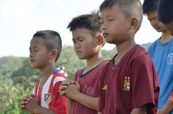 The football field is like a church for children to develop their faith.