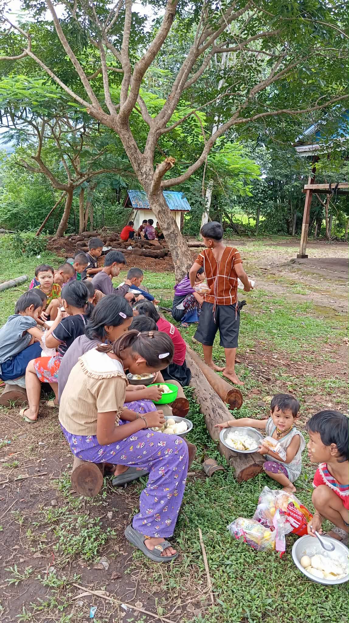 We sit and eat under the trees.