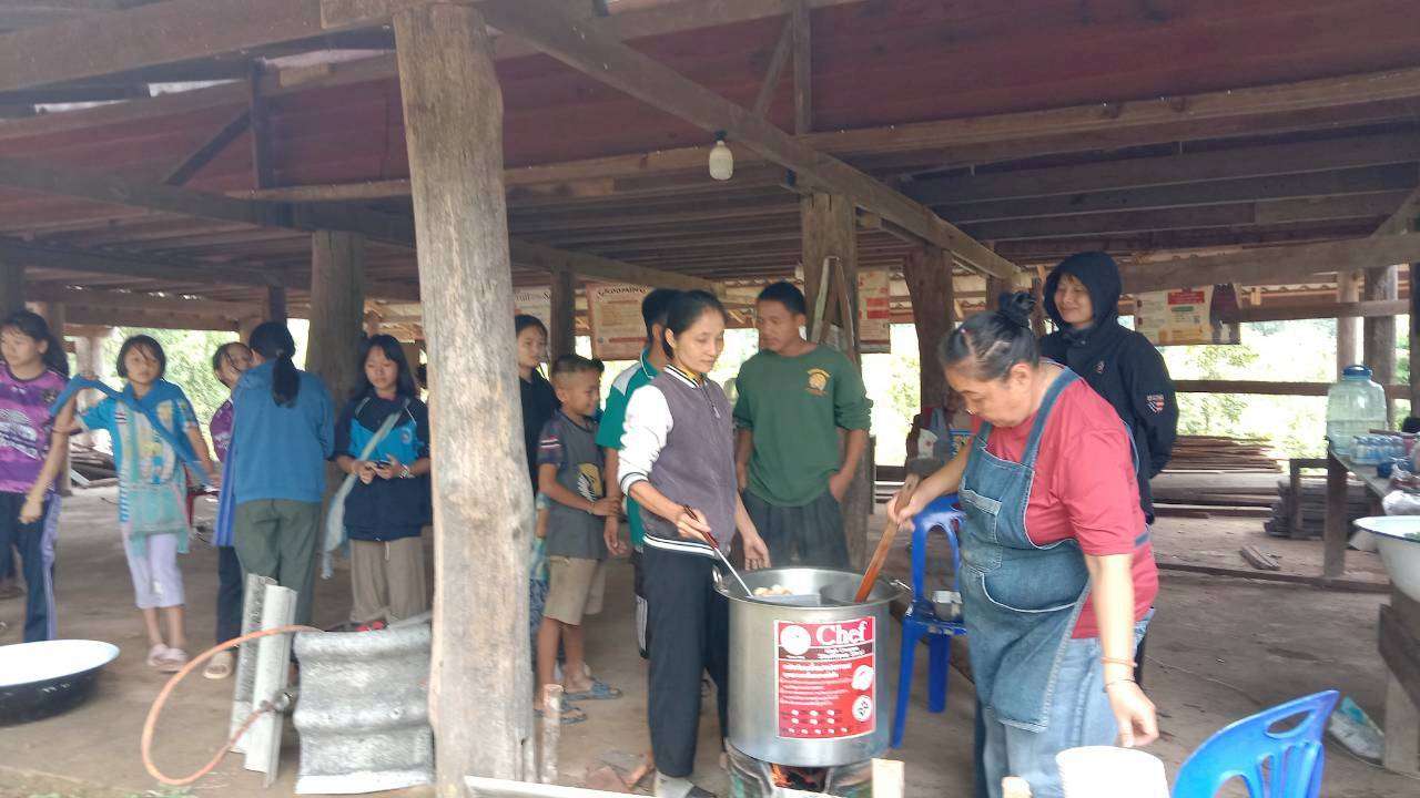 Community cooking session taking place under the church building.