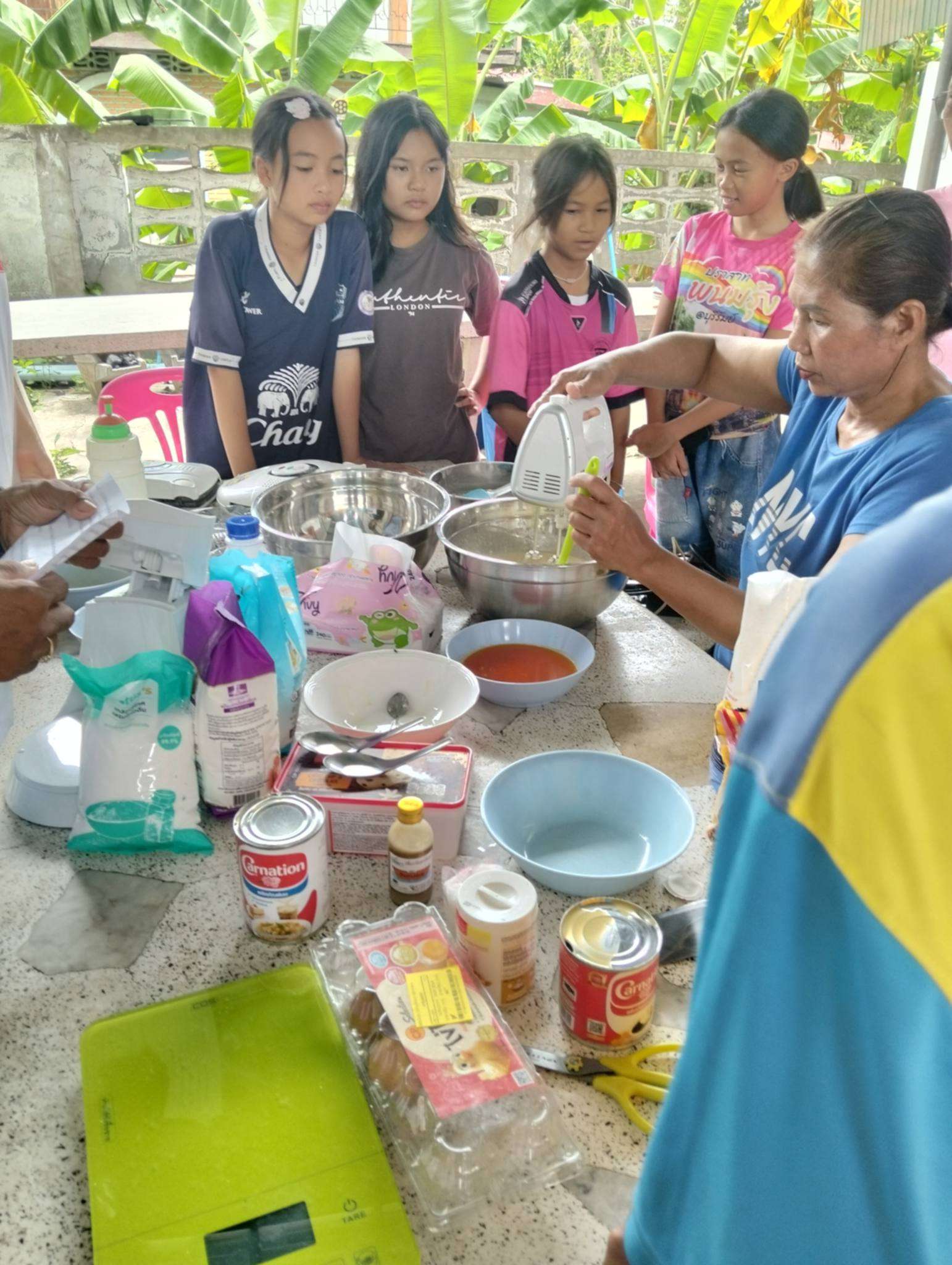 The instructor demonstrated how to mix the dough for the children.