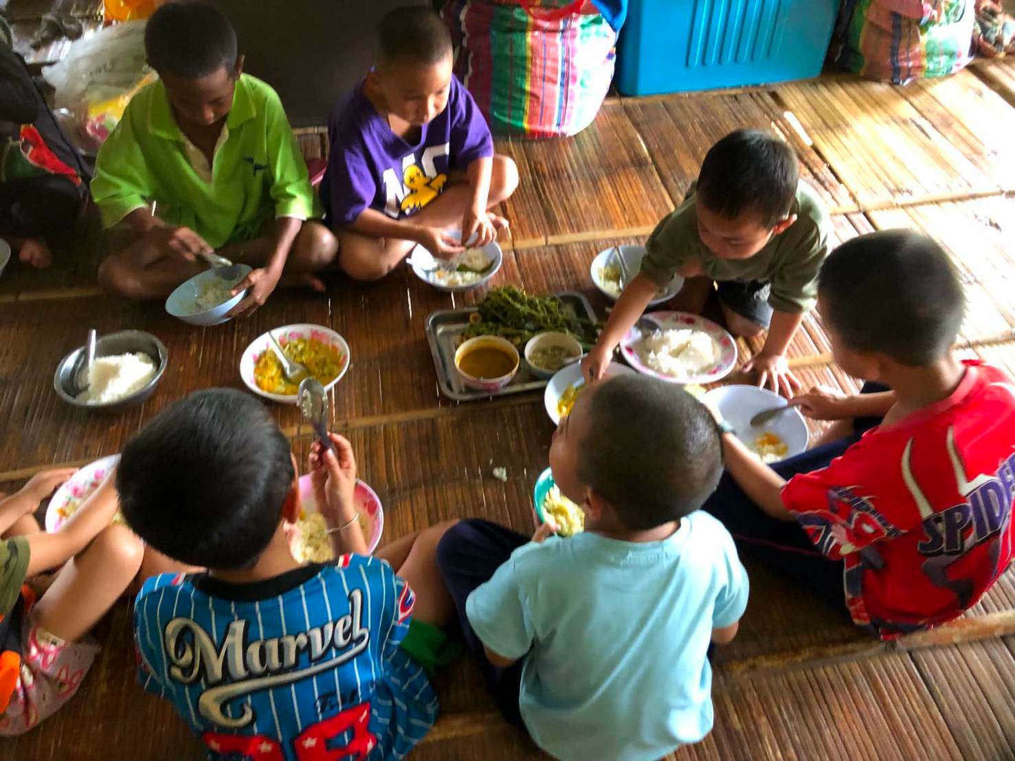 The children ate their meal while chatting happily.
