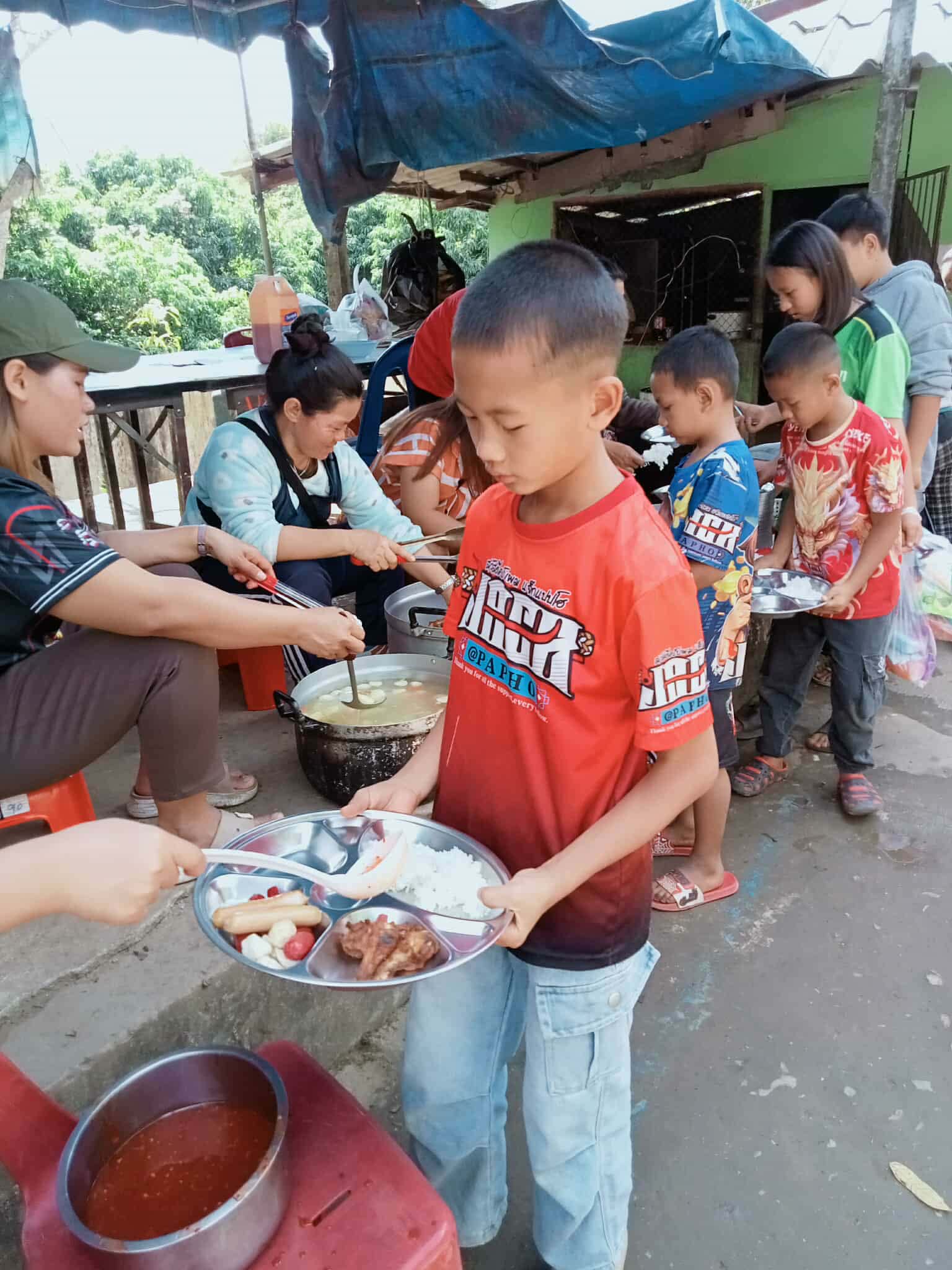 Church members come together, taking turns to cook and serve the children, fostering community spirit and nurturing hope with every meal.