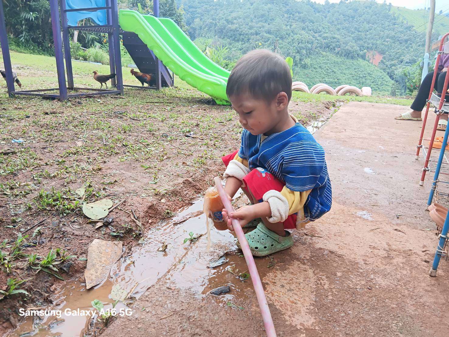 Children scoop up water for consumption.