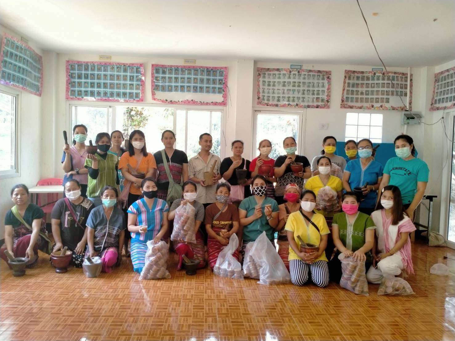 Group photo of youth and parents after the chili paste and salted fish class, showcasing their tasty creations and teamwork.