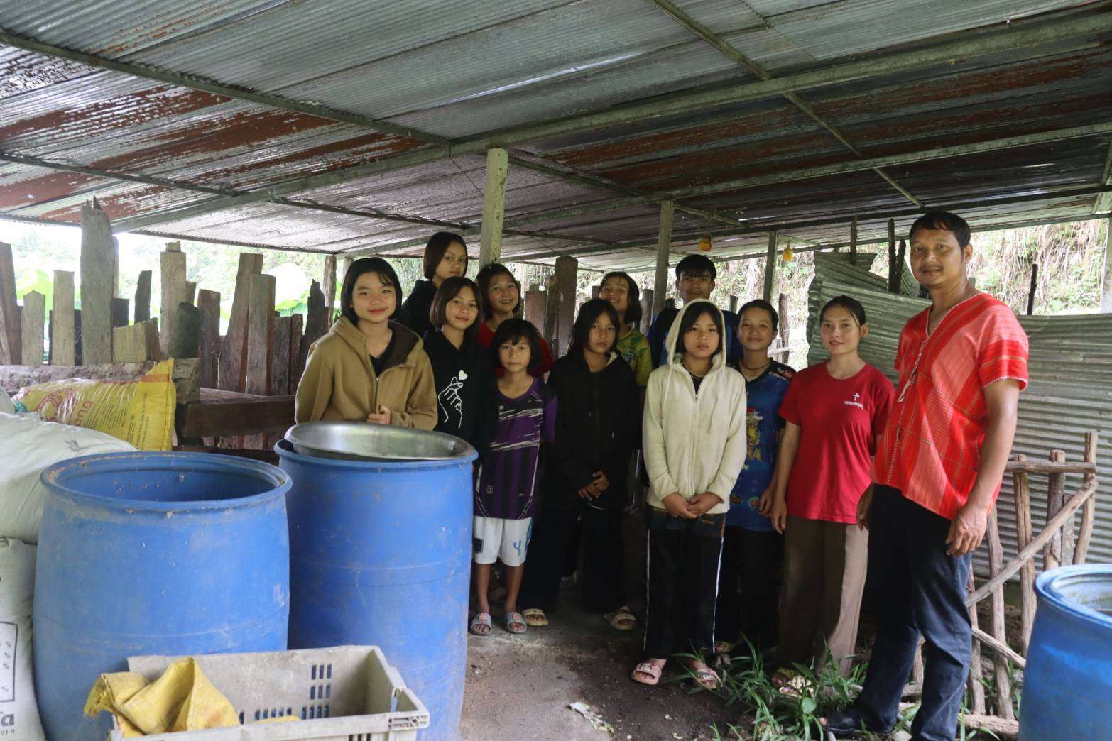 Children learning to care for pigs and developing skills for a pig farming career.