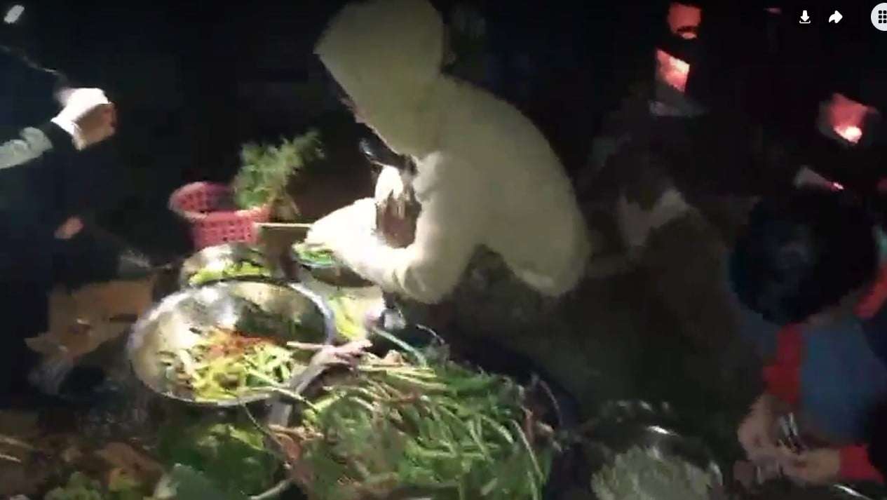 Children prepare dinner by candlelight, blending teamwork and tradition in the kitchen.