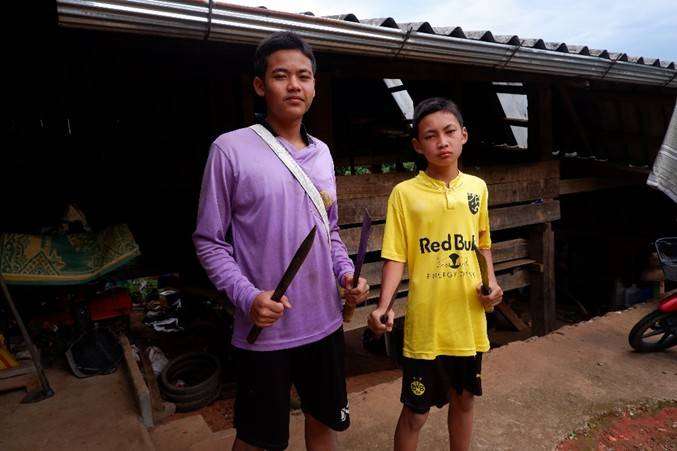 Youth and their knife-making skills after being taught and trained.