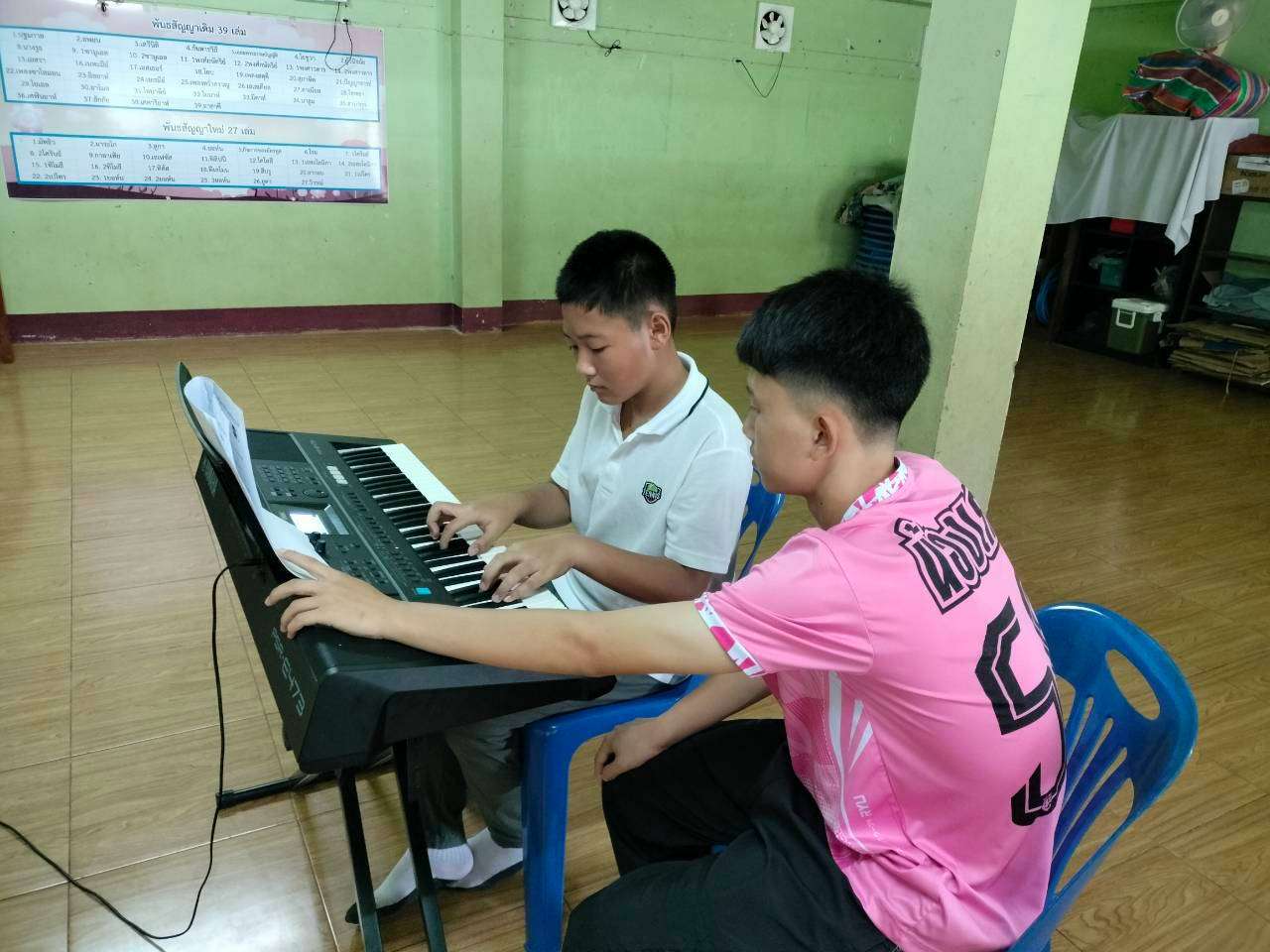 The young person is using their free time to diligently learn keyboard.
