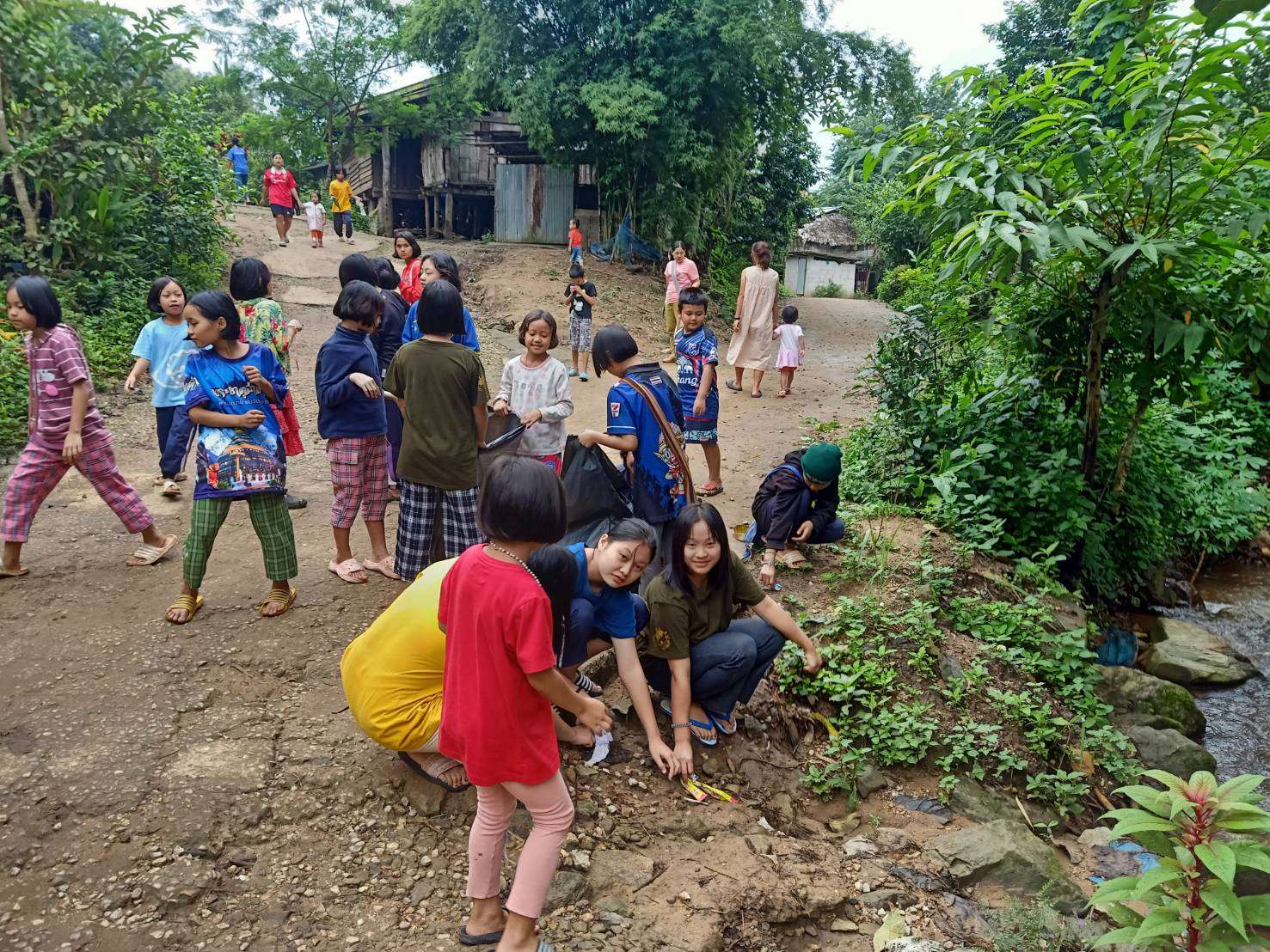 Collecting garbage along the stream in the village