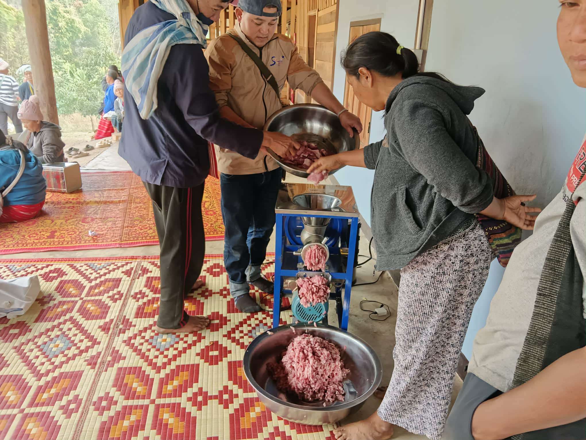 Grinding the pork to make fermented pork sausage (Naem Moo)