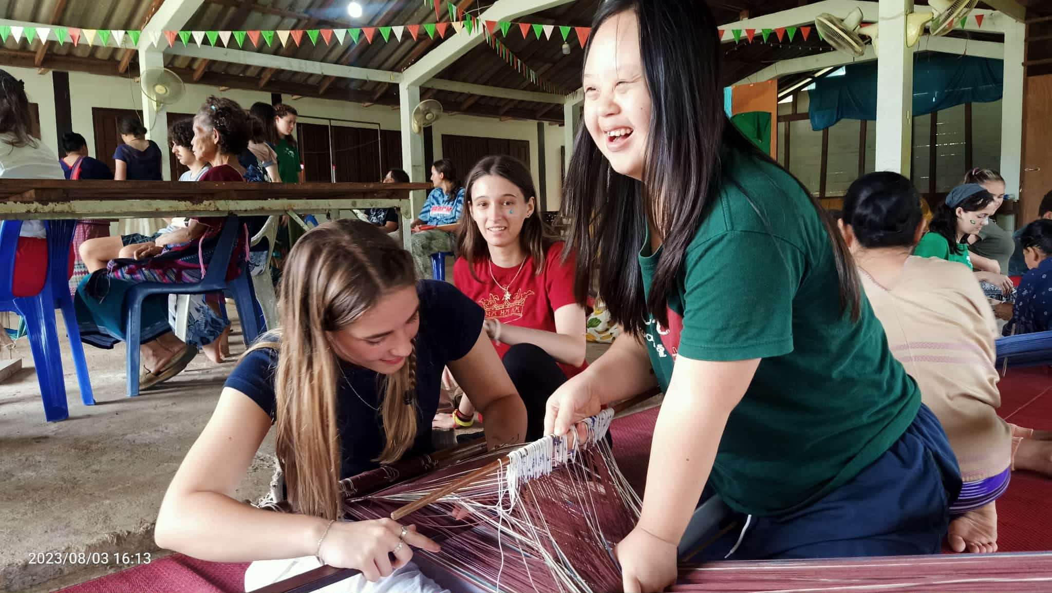 Passing Down Traditions: The children in the project proudly teach volunteers how to weave in the beautiful Karen style, sharing their skills and cultural heritage