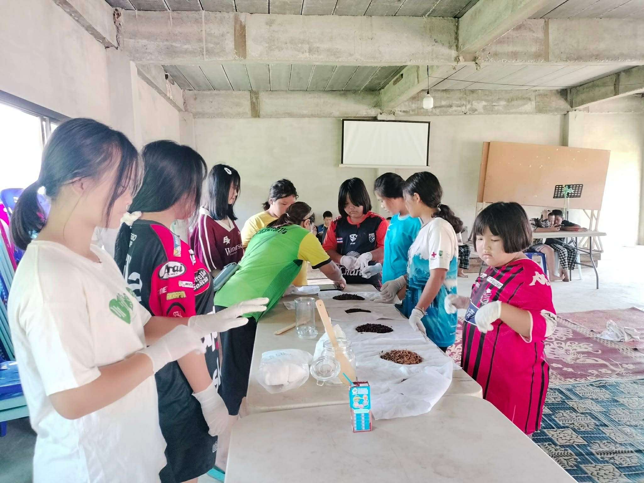 Children and youth engage in the herbal fermentation process, gaining valuable skills for crafting unique products.