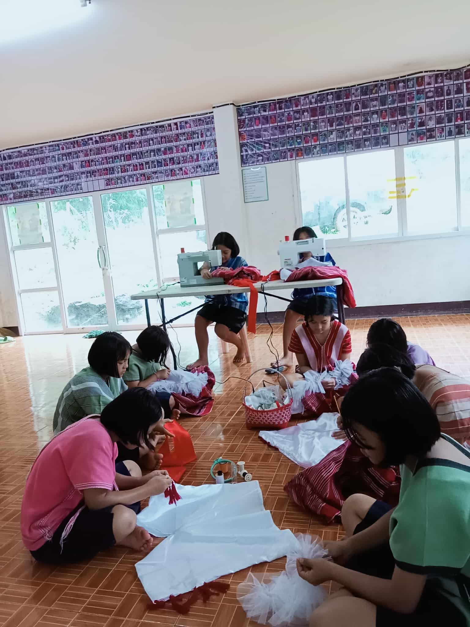 Children engaged in practicing sewing skills.