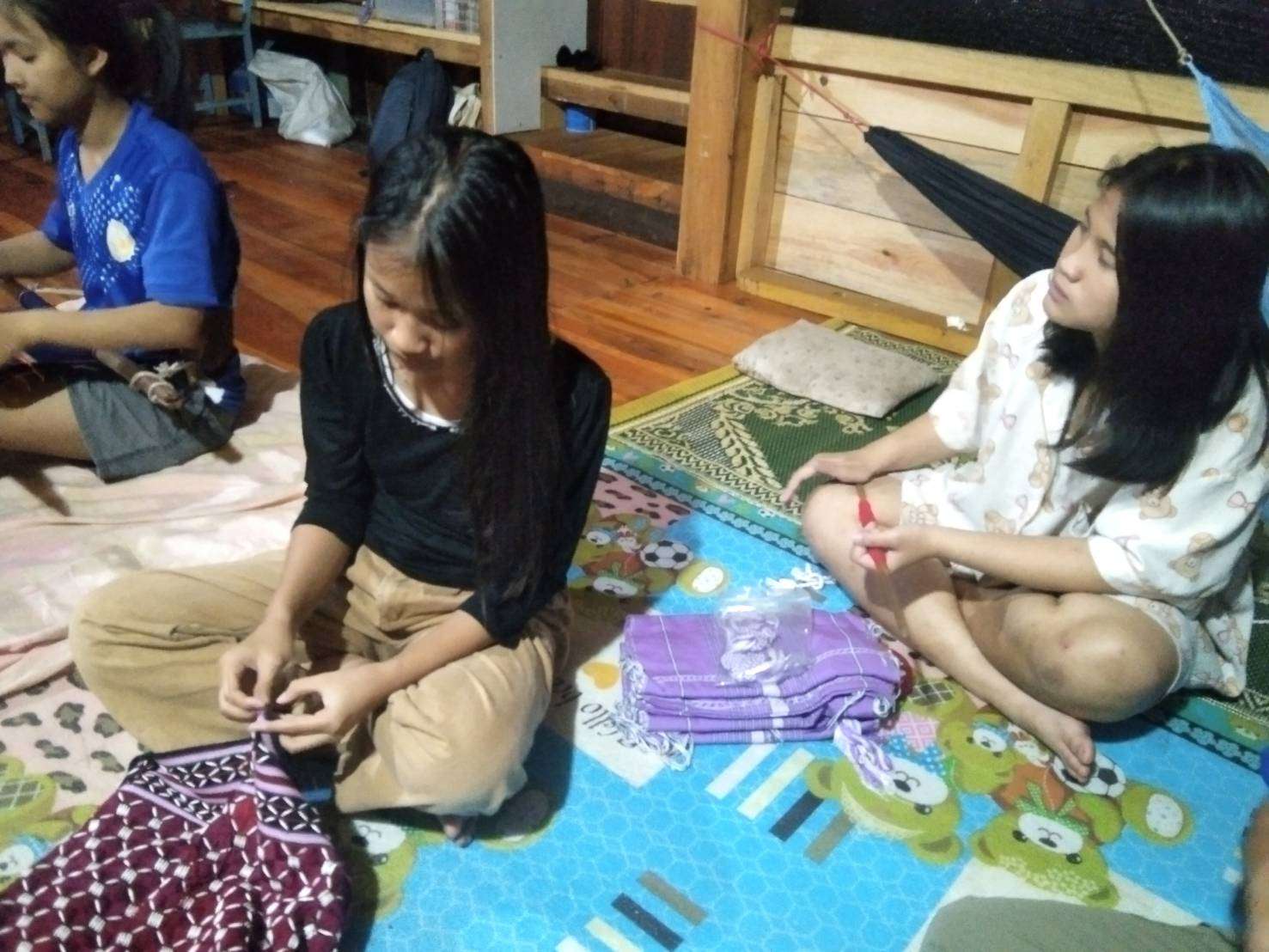 Embroidered on cloth by children using beads to create natural patterns.
