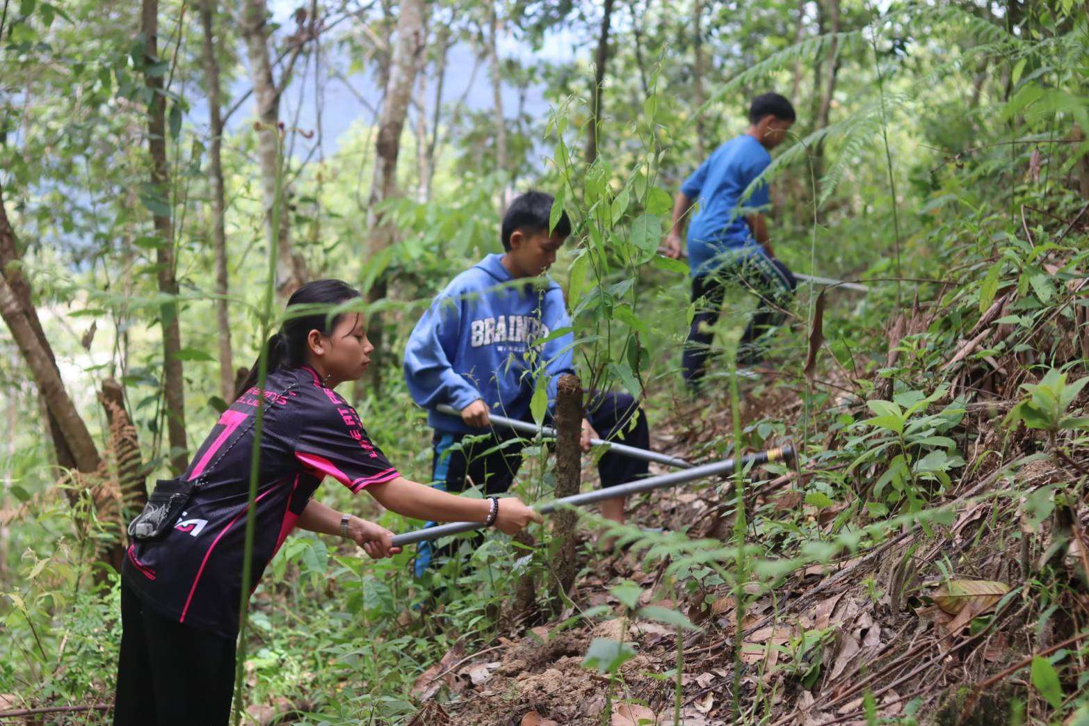 The dorm students are preparing an area to plant vegetables.