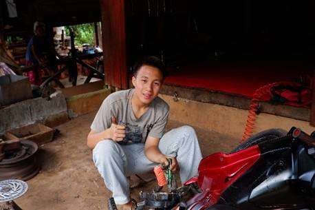 The young people are practicing disassembling and installing motorcycle parts.