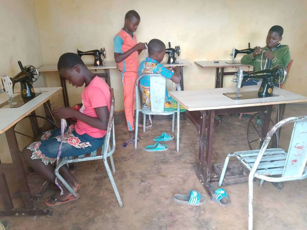 Youth learning to sew during the holidays