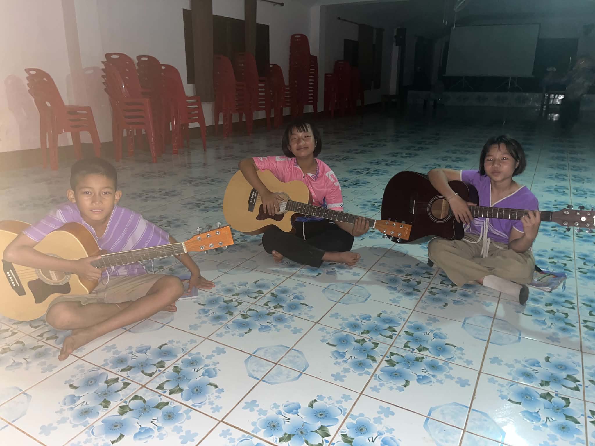 The group of children practiced music in the evening, when there was no electricity.