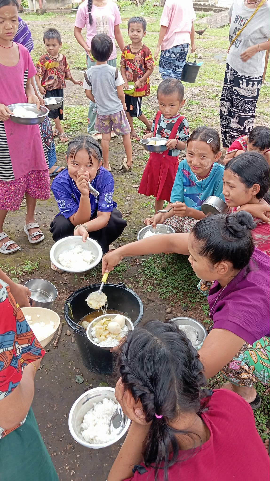 Food is distributed to the children around the cafeteria.