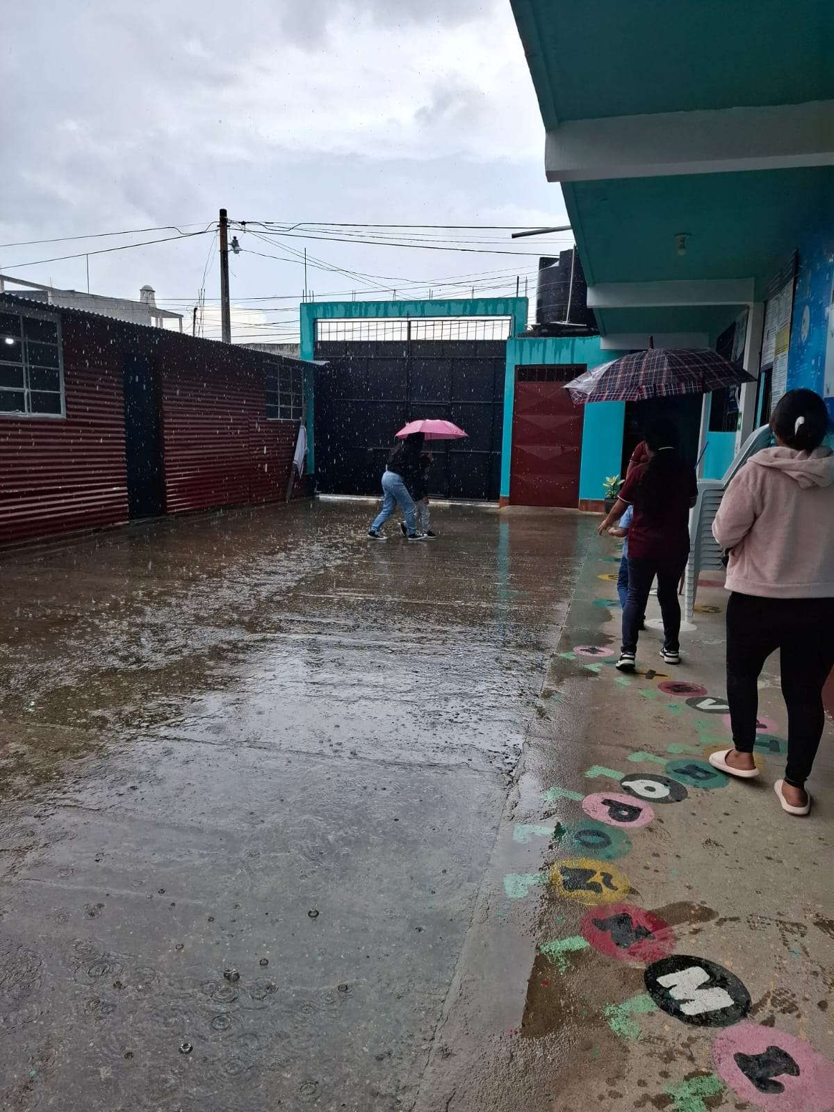 Tutor and participant crossing from kitchen to classroom.